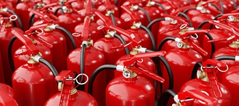 two fire extinguishers in industrial hallway